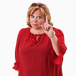 Karen-Marie wearing a red blouse and with her index finger raised